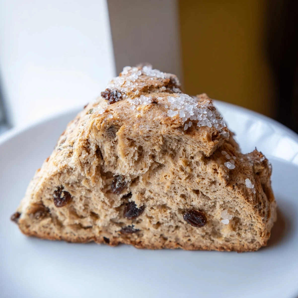 Golden wedges of Irish Soda Bread Scones with caraway seeds and raisins, ready to serve with tea.