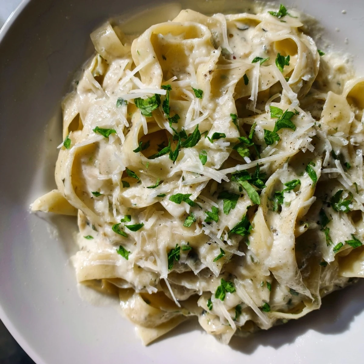 A close-up of Creamy Garlic Pasta with Fresh Herbs, showcasing silky sauce and herbs, ready to enjoy tonight.