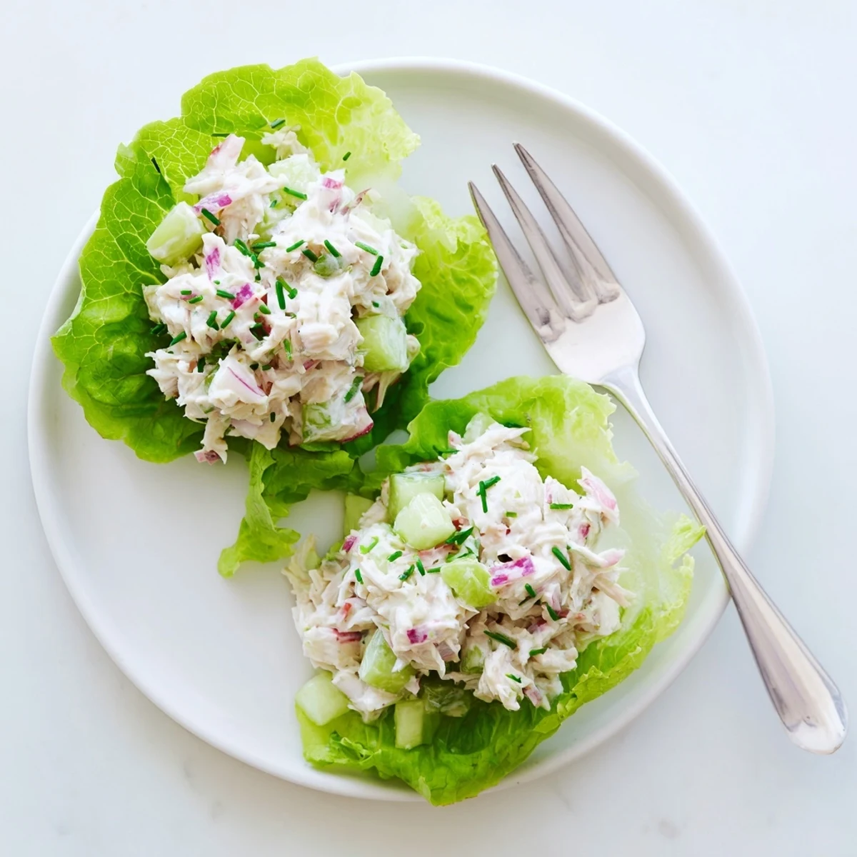 A close-up bowl of chilled crab salad with diced vegetables and fresh herbs, served as a light lunch.  