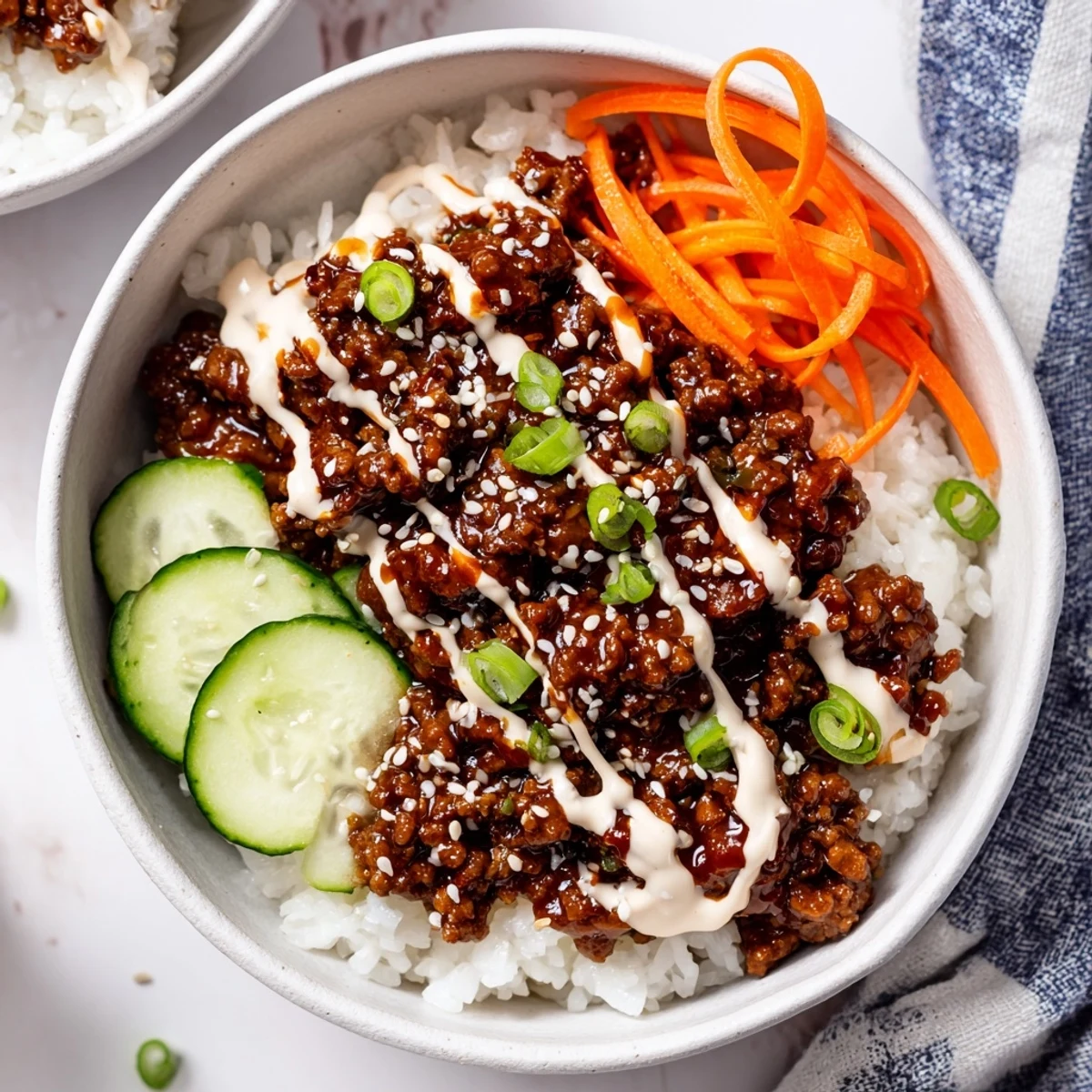 A close-up of the Korean Beef Bowl with Spicy Mayo shows tender beef, fluffy rice, and fresh veggies.