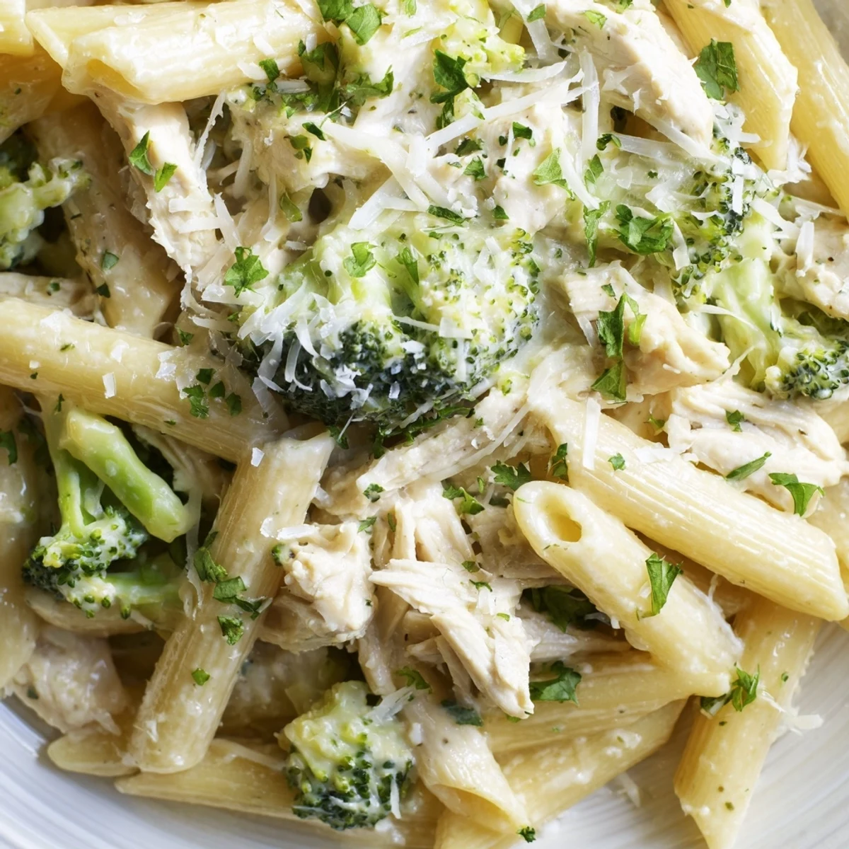 Creamy rotisserie chicken broccoli pasta tossed in garlic Parmesan sauce and garnished with fresh parsley