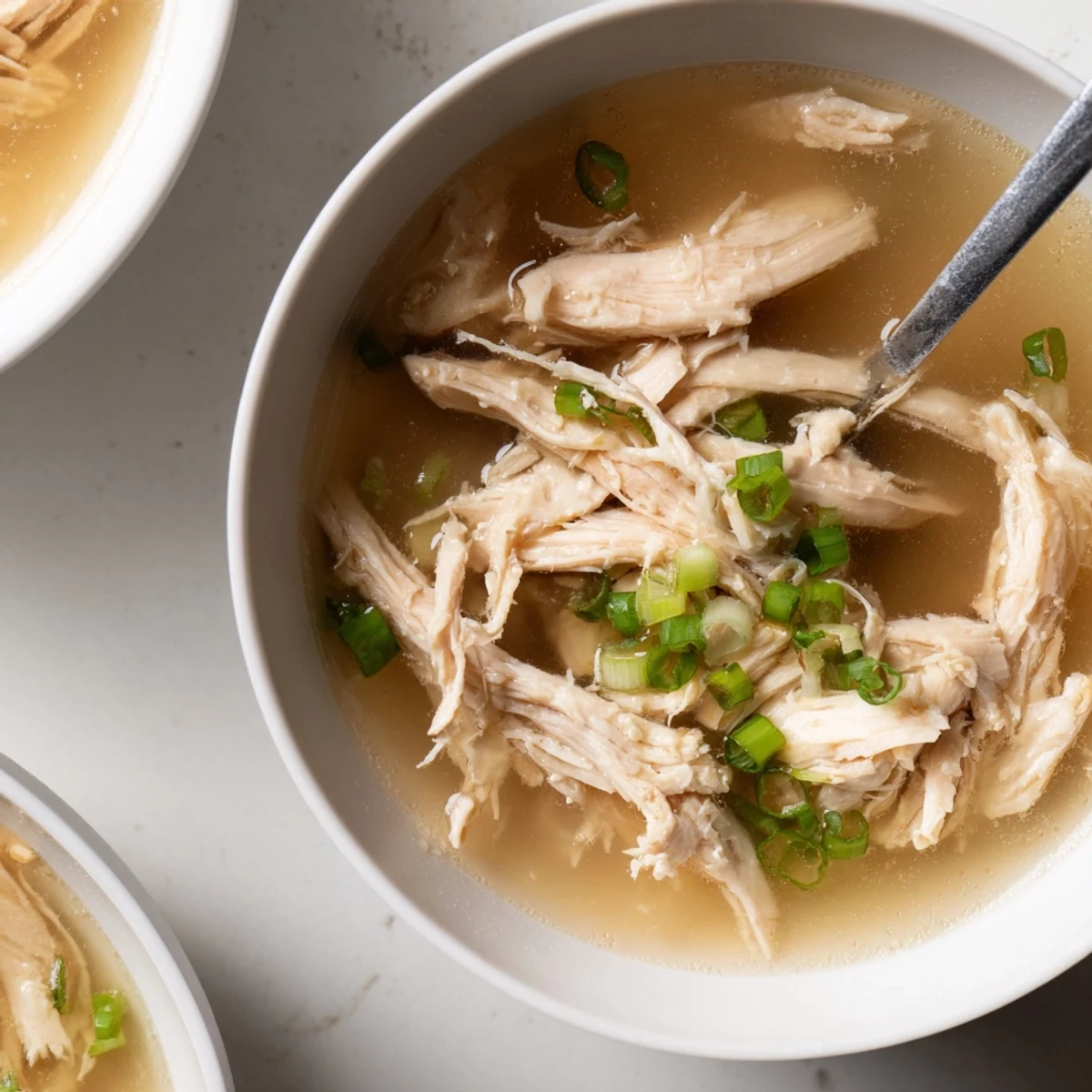 Comforting Dakgomtang soup with fluffy white rice and savory dipping sauce alongside