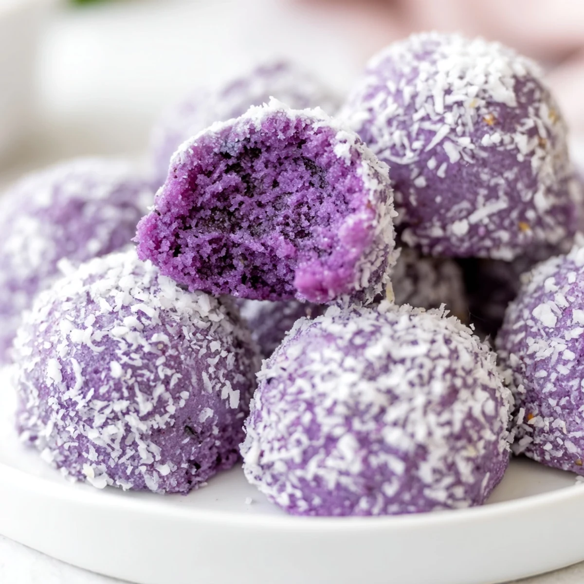 Purple Coconut Ube Besito cookies arranged on a rustic wooden board for afternoon tea