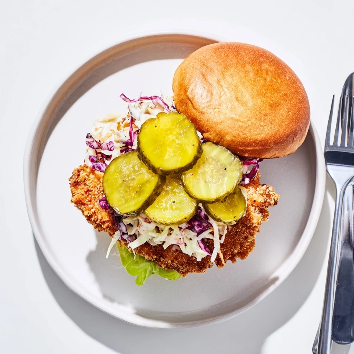 Homemade Southern fried chicken burgers featuring crunchy spiced coating with fresh dill pickle slices