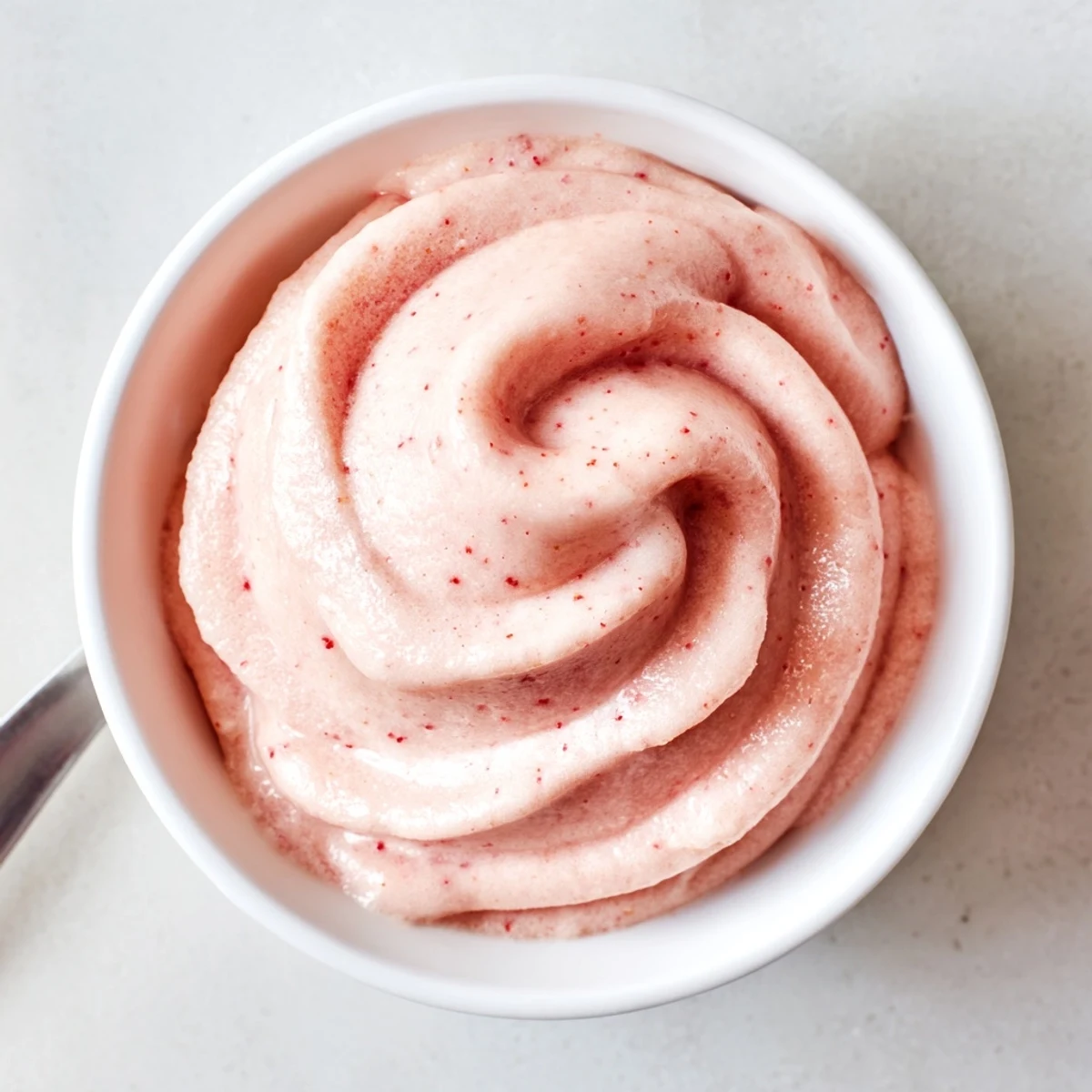 Creamy frozen strawberry Dole Whip delight served in a swirl with fresh strawberry topping