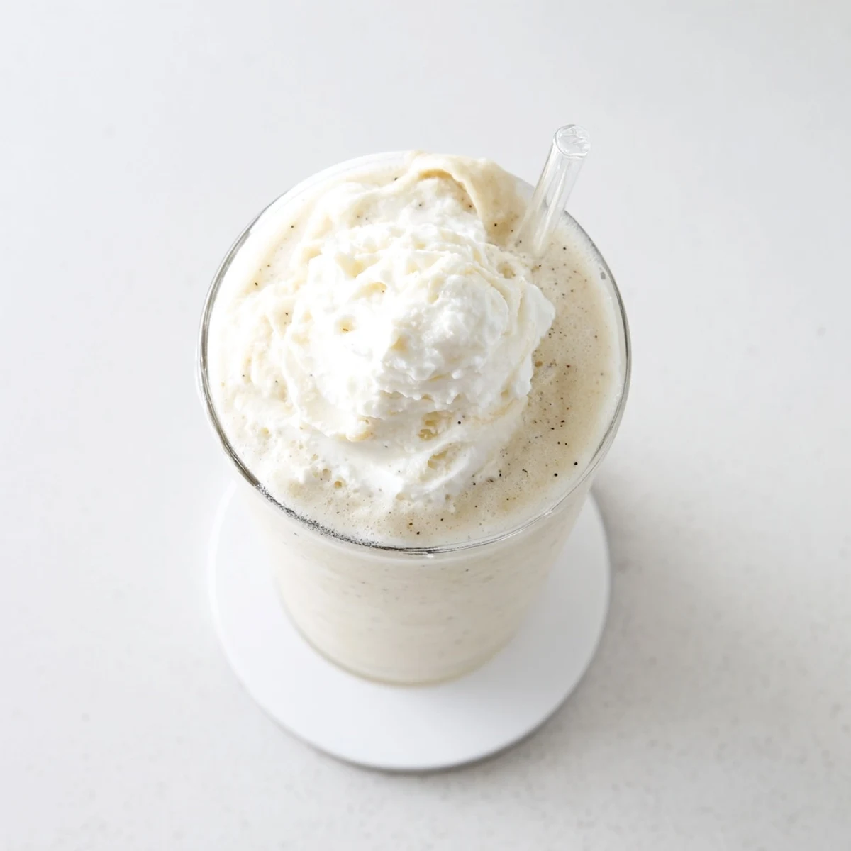 Creamy vanilla bean frappuccino topped with whipped cream in chilled glass