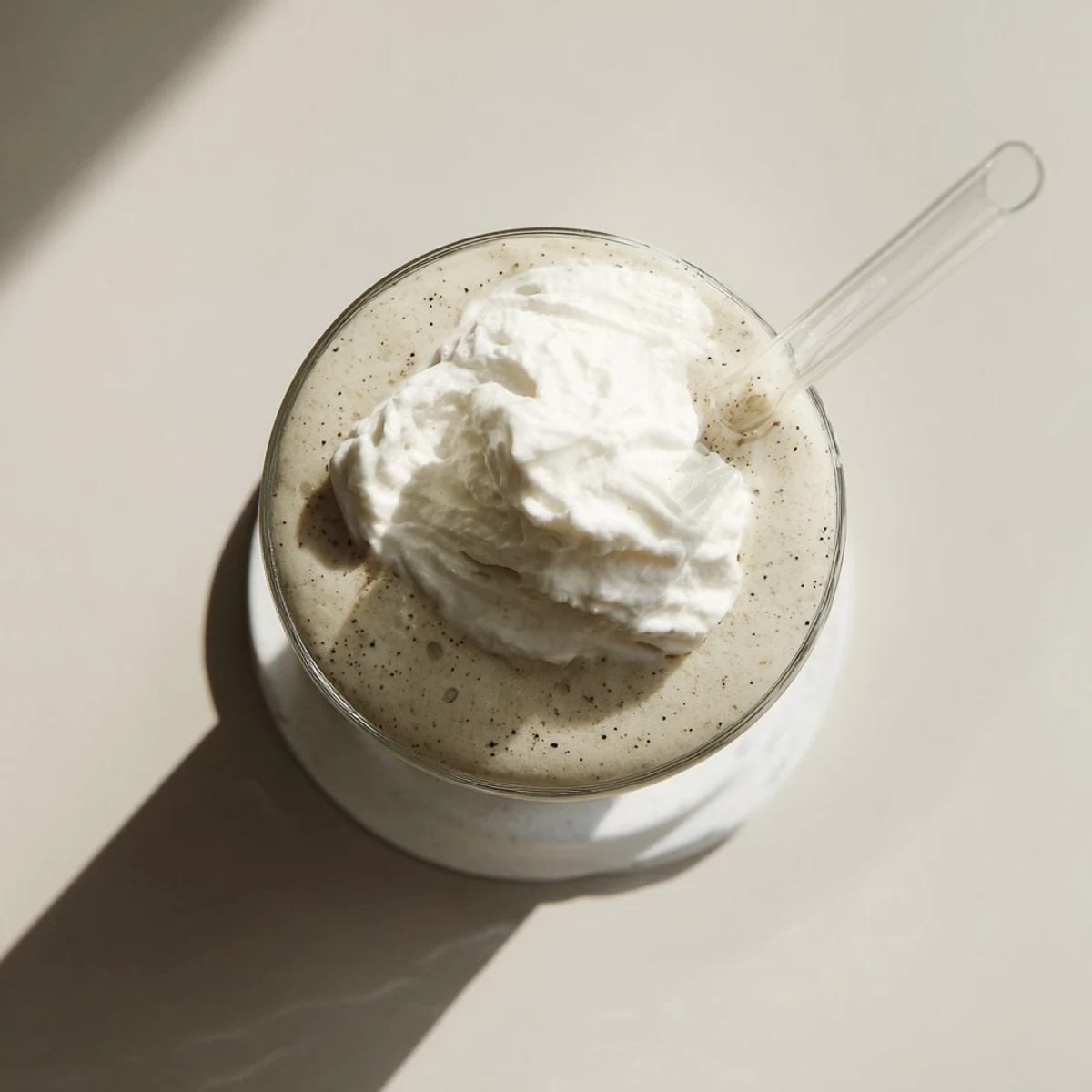 Frosty vanilla bean frappuccino served with dollop of sweetened whipped cream