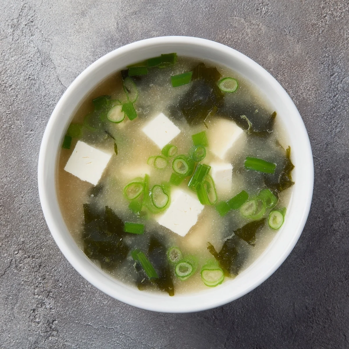 Golden broth of easy authentic miso soup served in traditional ceramic bowl with toppings