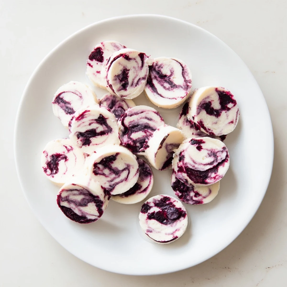 Close-up of healthy blueberry swirl yogurt bites showing marbled blueberry compote swirled into smooth vanilla Greek yogurt squares