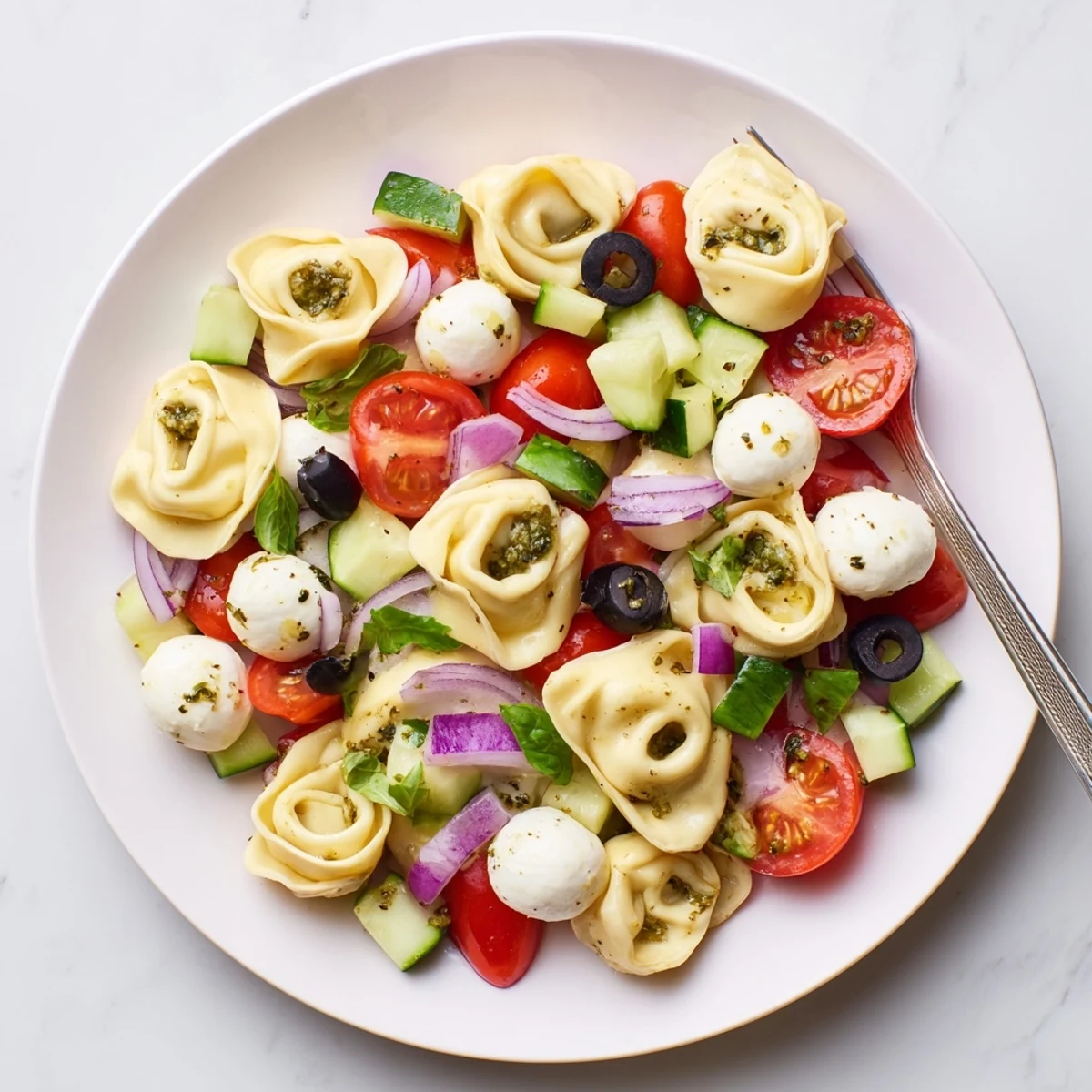Creamy cheese tortellini pasta salad tossed with crisp vegetables and zesty Italian dressing