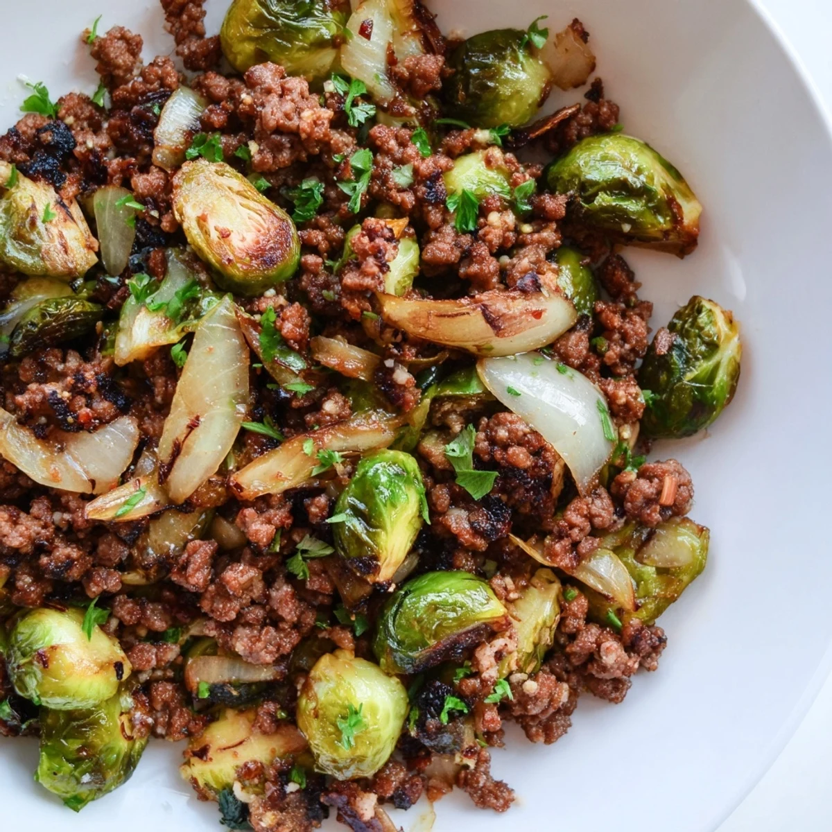 Savory ground beef and Brussels sprouts skillet topped with fresh parsley and Parmesan cheese