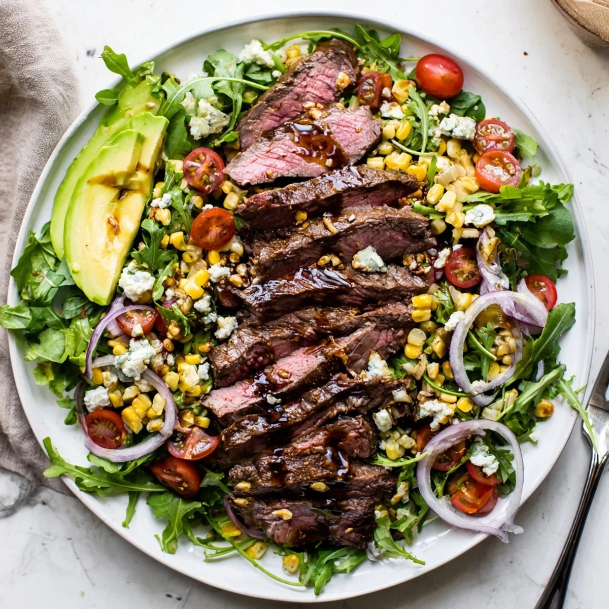 Balsamic steak Gorgonzola salad drizzled with vinaigrette and topped with sweet grilled corn kernels