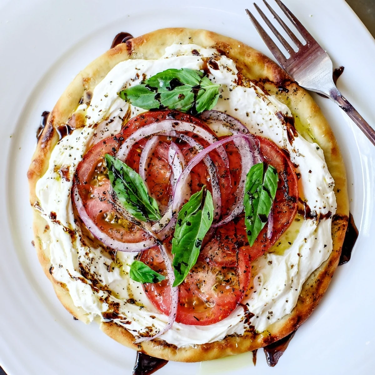 Warm Caprese Pita Pizza With Whipped Garlic Feta, golden edges and melted cheese.