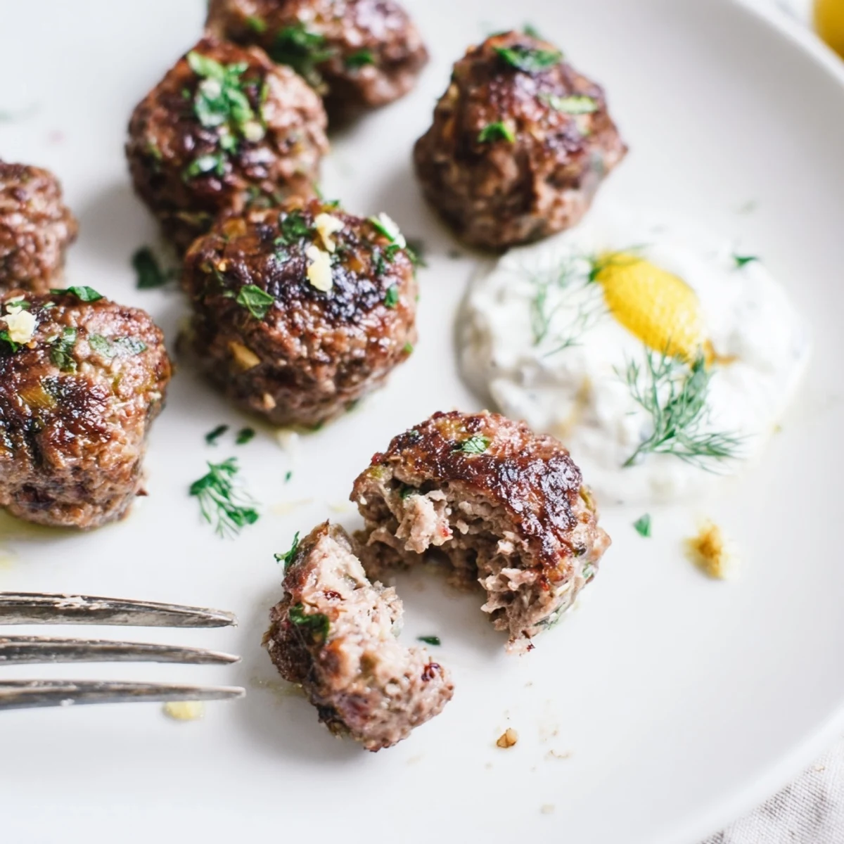 Plate of Greek Style Beef Meatballs garnished with lemon zest and parsley